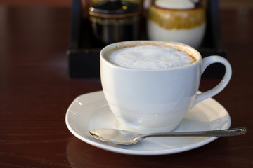 Hot cappuccino in white cup