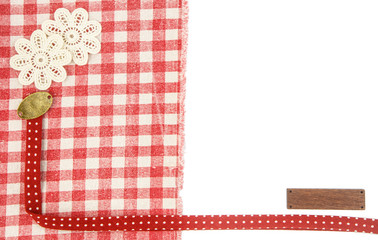 red fabric wih floral and wood tag as background