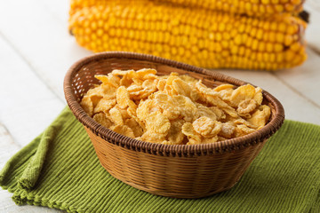 Cornflakes in bowl on table