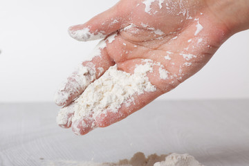Hands and white wheat flour