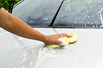 man and sponge for cleaning car and washing car