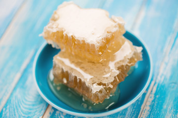 Honeycomb pieces in a saucer, horizontal shot