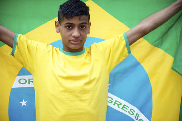 Proud Young Brazilian Football Fan Holds Brazilian Flag