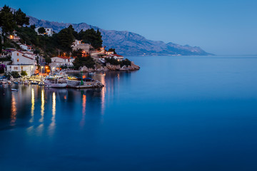 Fototapeta na wymiar Peaceful Croatian Village and Adriatic Bay Illuminated by Moon,