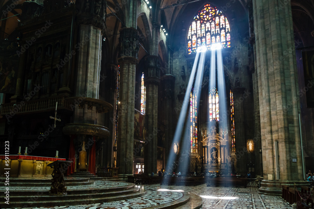 Wall mural the bright beam of light inside milan cathedral, italy