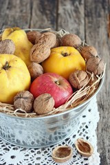 Ripe quince,apples and nuts in the rustic bowl