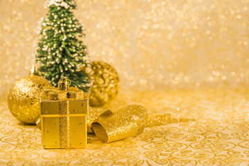 Christmas ornaments and snowed fir on shiny background