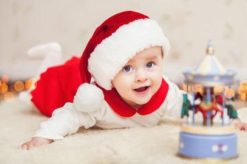 Obraz na płótnie Canvas Cute baby in suit of Santa's little helper
