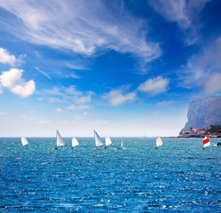 Sailboats Optimist learning to sail in Mediterranean at Denia