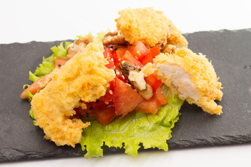 fried chicken fillet with vegetables isolated