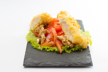 fried chicken fillet with vegetables isolated