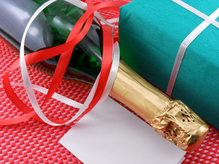Bottle of a champagne and green gift boxes