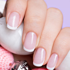 woman's nails with beautiful french white manicure