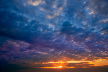 Naklejka na ściany i meble Dramatic sky with stormy clouds in sunset