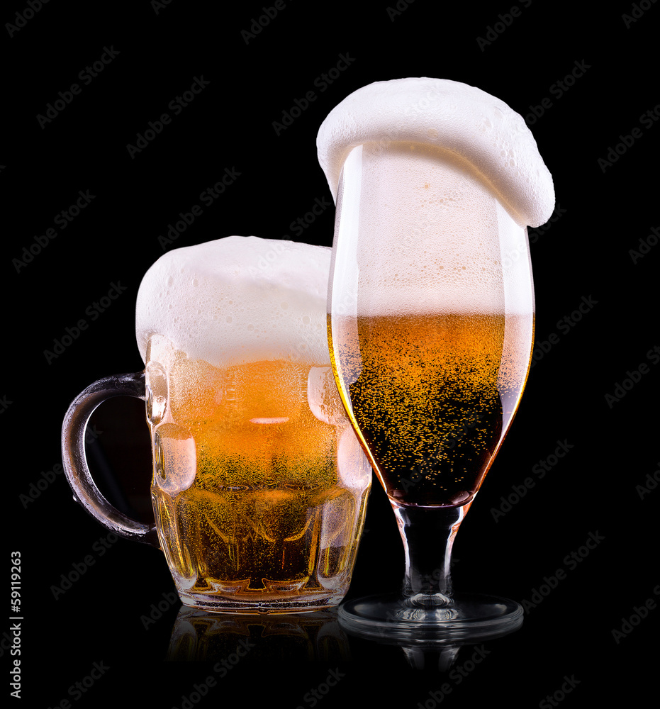 Wall mural Beer into glass on a black