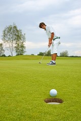 Golf, Golfer thrusting the ball into the hole