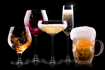 set with different drinks on black background