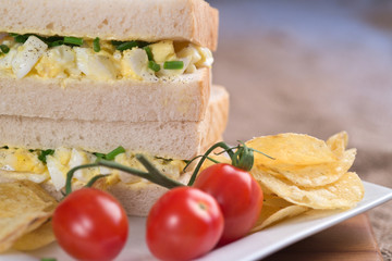 Fototapeta na wymiar Fresh egg on white sandwich in rustic kitchen setting