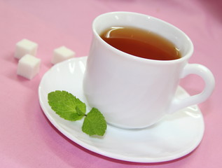Сup of tea on pink background