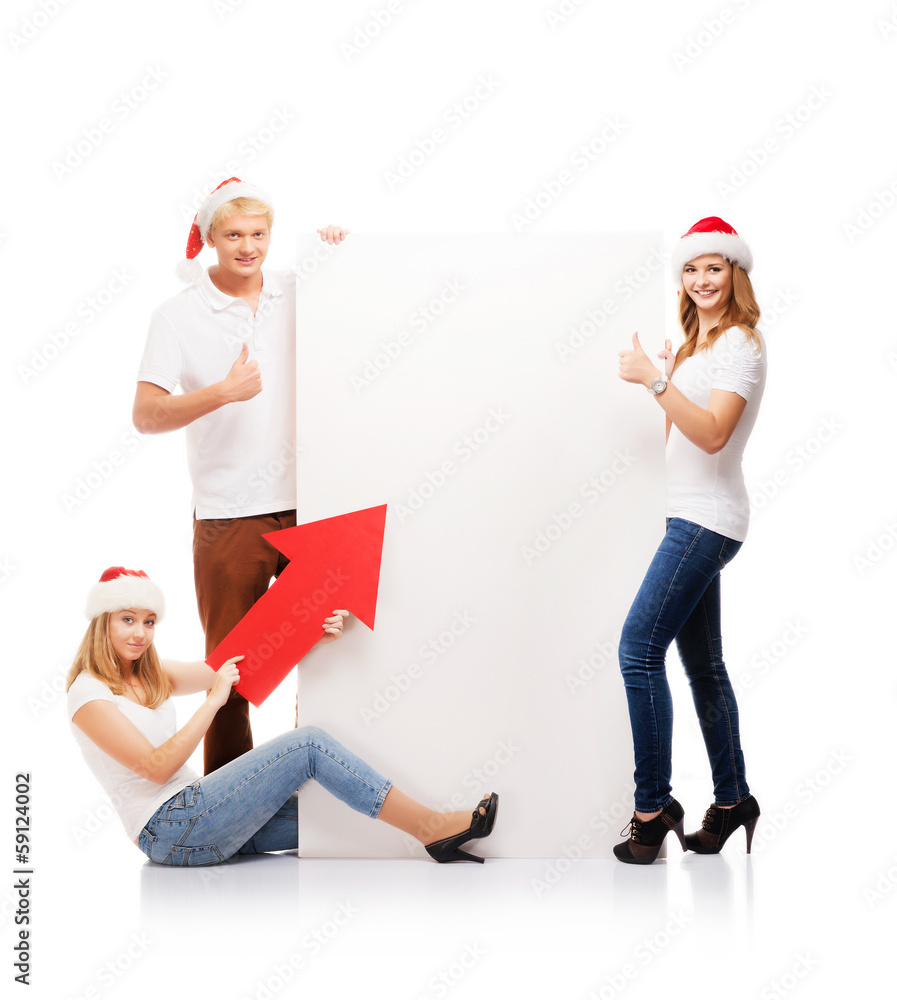 Poster three happy teenagers in christmas hats with a white banner