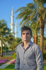 A young man in a park near the mosque