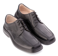 Black glossy man’s shoes with shoelaces