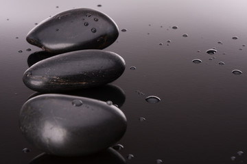 Spa stone arrangement on black surface. Healthcare concept.