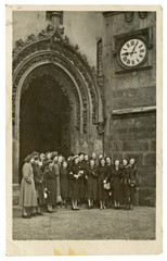 CIRCA 1949 - young women before old building