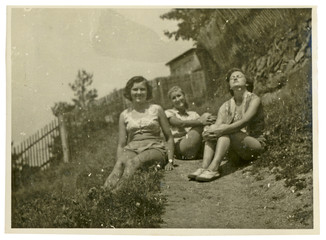 Two girls are sunbathing in the sun - circa 1950 - 59127675