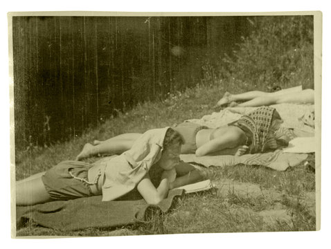Two girls are sunbathing in the sun - circa 1950