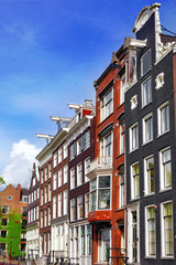 Fototapeta premium Amsterdam and typical houses with clear summer sky.Netherlands