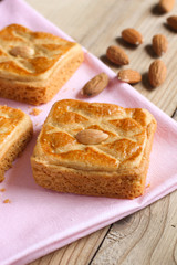 Almond biscuits on pink tablecloth closeup