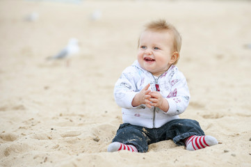 Little Kid on Sand Beach and Seagulls