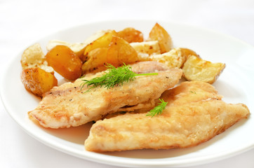 Fried fish fillet with baked potatoes