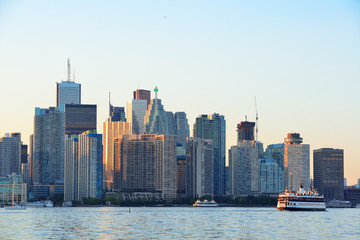 Fototapeta na wymiar Toronto skyline with boat, urban architecture and blue sky