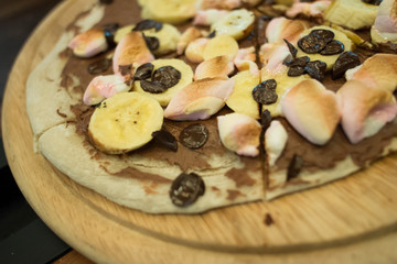 Dessert pizza with chocolate banana and marshmallow.