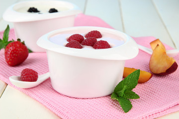 Delicious yogurt with fruit and berries on table close-up