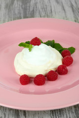 Tasty meringue cake with berries on wooden table