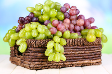 Ripe green and purple grapes in basket