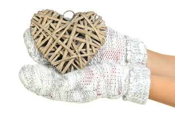 Female hands in mittens with heart, close-up