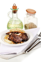 Appetizing fried chicken livers on plate isolated on white