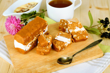 Tasty sherbet with nuts on plate on wooden table close-up