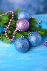 Christmas balls on fir tree, on color background