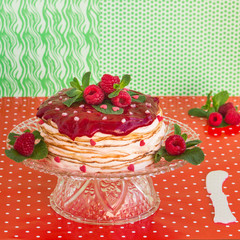 Delicious layered cake topped with raspberry and mint, green