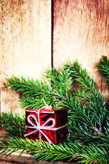 Red Gift Boxes and fir tree branch on rustic wood background wit