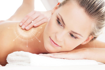 Obraz na płótnie Canvas A young and beautiful woman on a back massage procedure
