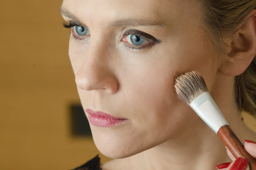 Young woman in make - up process