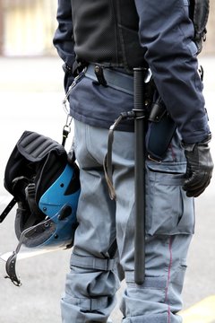 policeman with truncheon, helmet gun and handcuffs