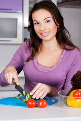 Pretty  woman cooking food in the kitchen