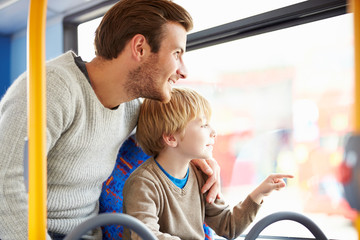 Father And Son Enjoying Bus Journey Together